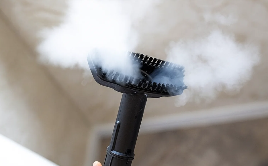 Close-up of a handheld steam cleaning machine releasing hot steam for Deep Cleaning Vancouver.
